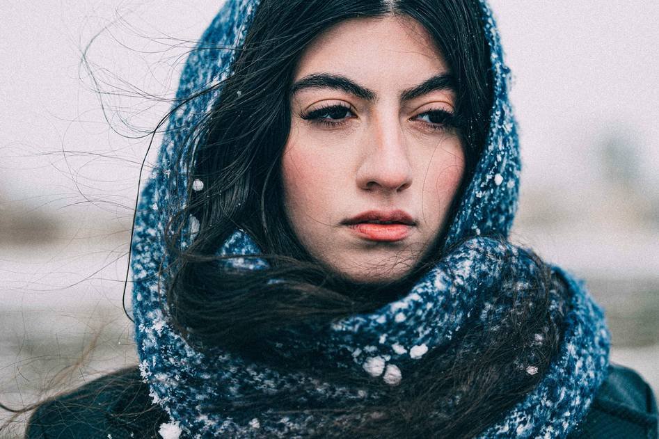 Elegant woman wearing a soft pink silk hair scarf in natural light