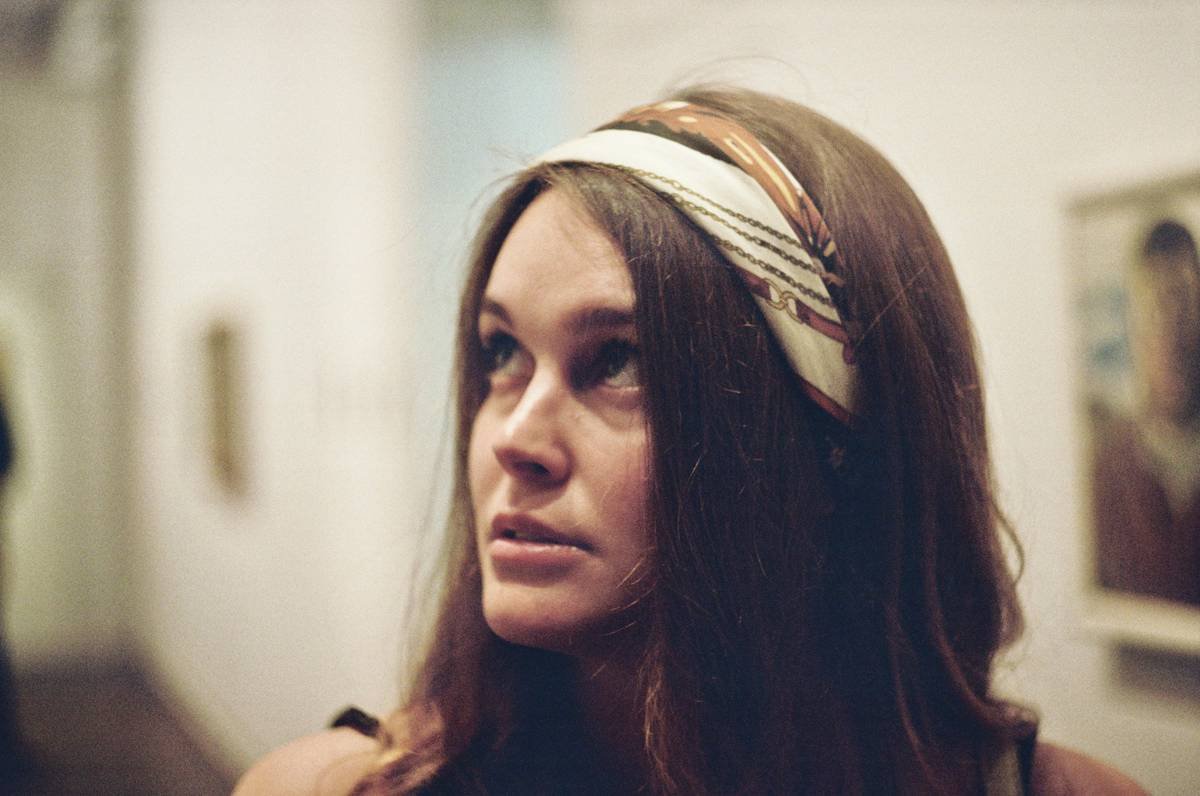 woman wearing a silk casual head band styled as an everyday hair scarf