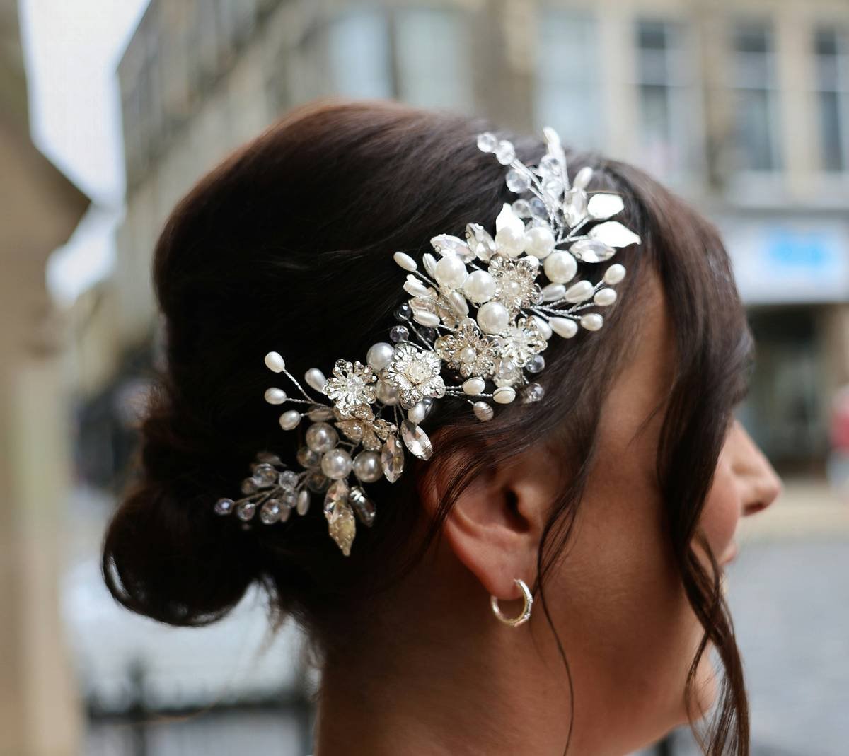 Woman styling ornate hair band with silk scarf for everyday elegance